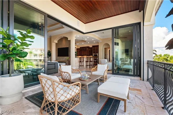 a view of a patio with couches table and chairs and potted plants