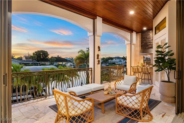a balcony with furniture and a floor to ceiling window