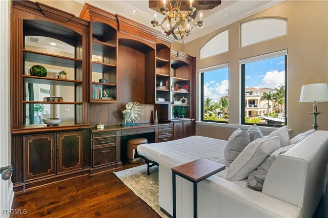 a view of a dining room with furniture a chandelier and window