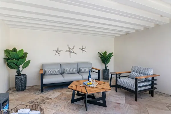 a living room with furniture flowerpot and a rug
