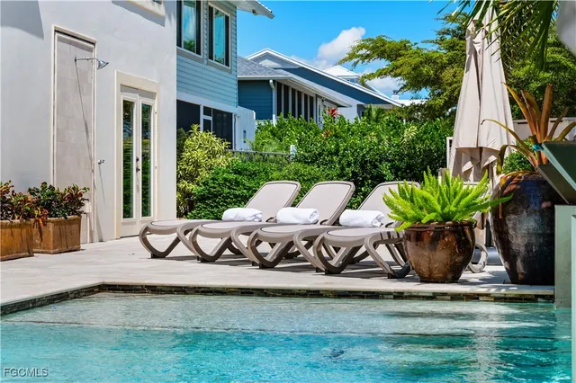 a view of a house with backyard and sitting area
