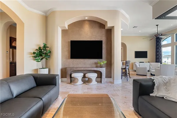 a living room with furniture a fireplace and a flat screen tv