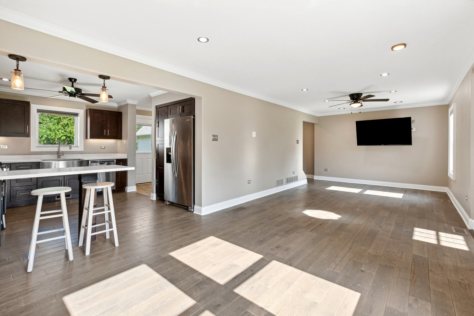 825 South Prairie Road New Lenox, IL 60451 - Photo 12 of 42 a living room with stainless steel appliances kitchen island furniture and a flat screen tv