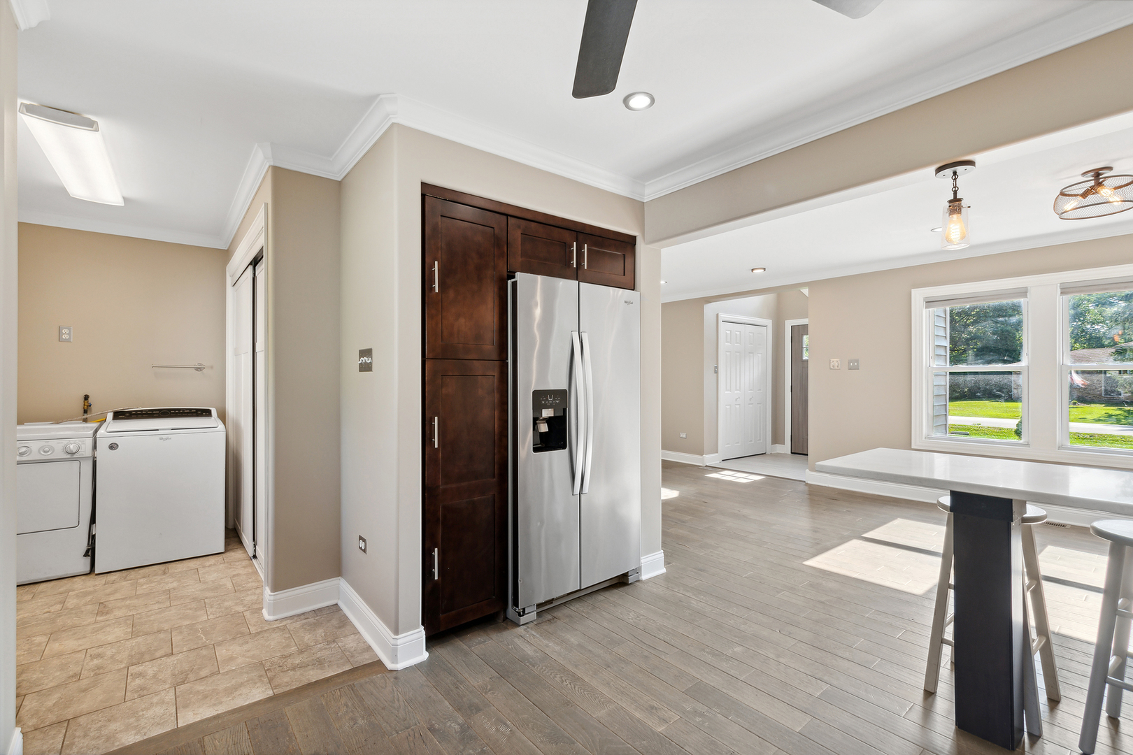 825 South Prairie Road New Lenox, IL 60451 - Photo 16 of 42 a view of a hallway with wooden floor and a kitchen
