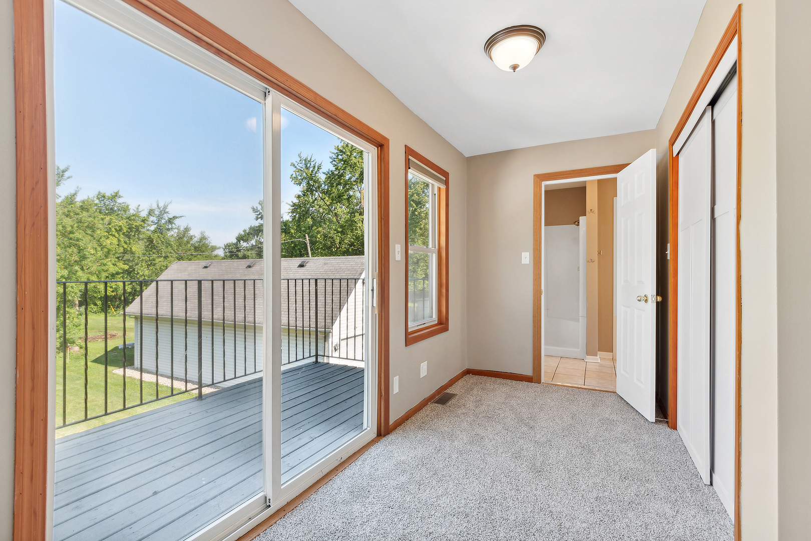 825 South Prairie Road New Lenox, IL 60451 - Photo 22 of 42 a view of a balcony with wooden floor and fence