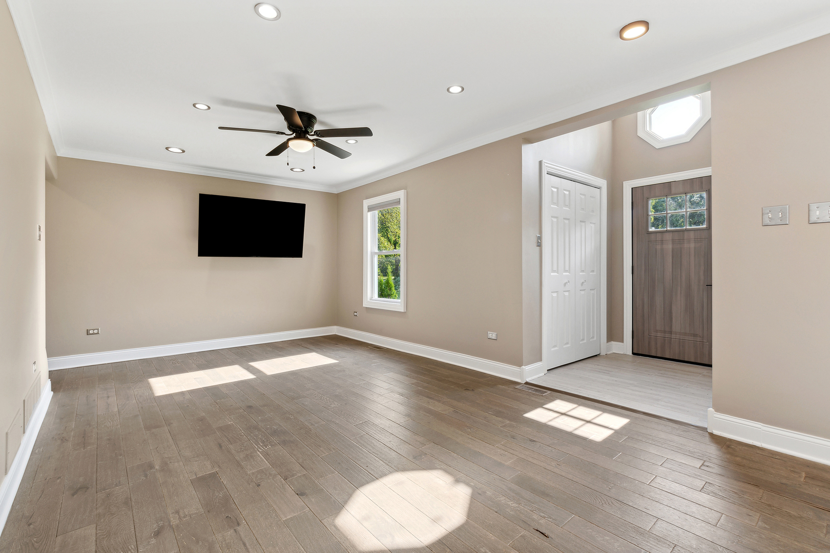 825 South Prairie Road New Lenox, IL 60451 - Photo 10 of 42 a view of a livingroom with a flat screen tv and wooden floor
