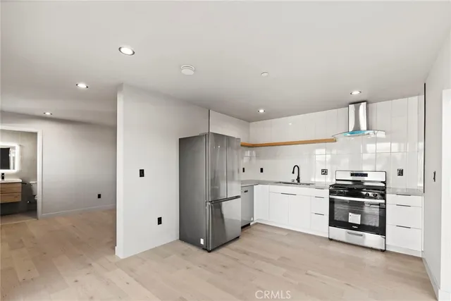 a kitchen with stainless steel appliances a refrigerator sink and cabinets