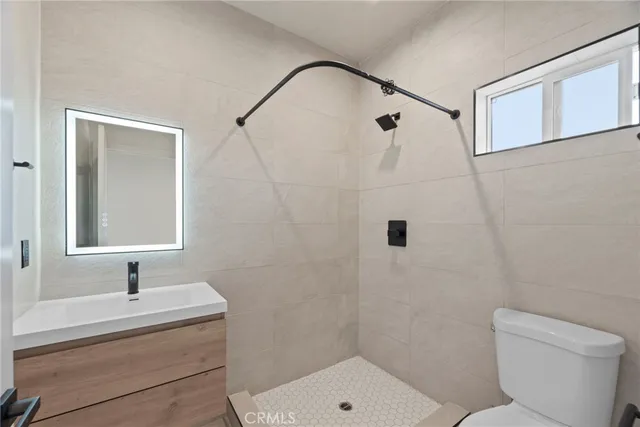 an empty room with a window and mirror