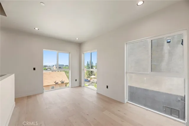 a kitchen with a sink a refrigerator and cabinets