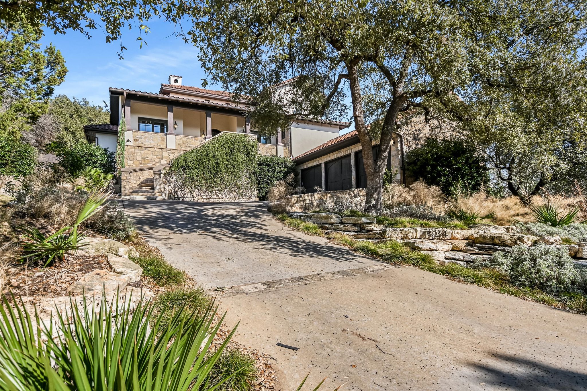 624 Logans Lane Austin, TX 78746 - Photo 1 of 1 a view of a house with a yard covered with trees
