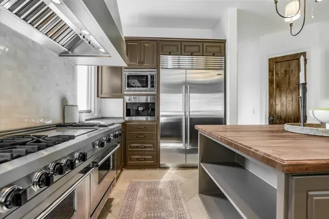 a kitchen with a stove and a refrigerator