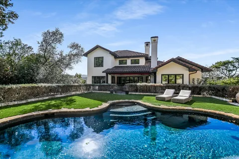 a house view with a seating space and garden
