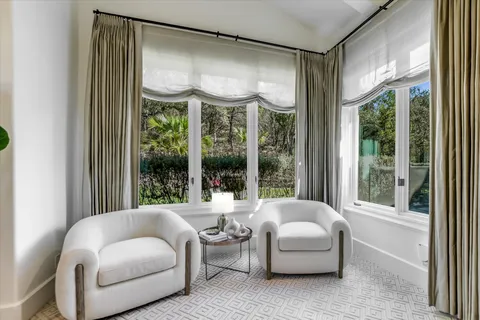 a living room with furniture and a large window with outer view