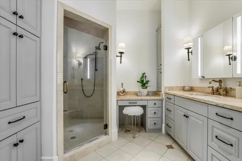 a bathroom with a shower sink and mirror