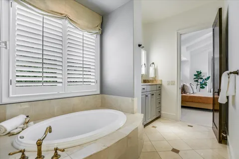 a bathroom with a tub sink and a window