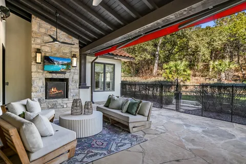 a living room with furniture and a floor to ceiling window