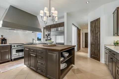 a kitchen with stainless steel appliances granite countertop a stove and a refrigerator