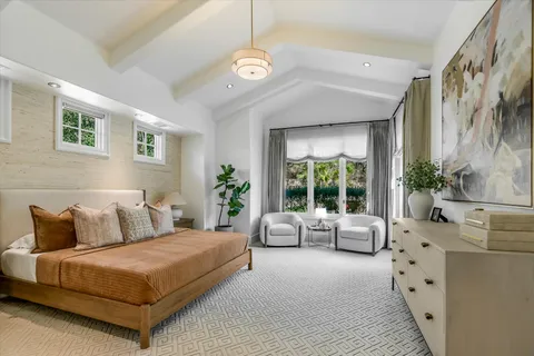 a bedroom with a large bed and a couch