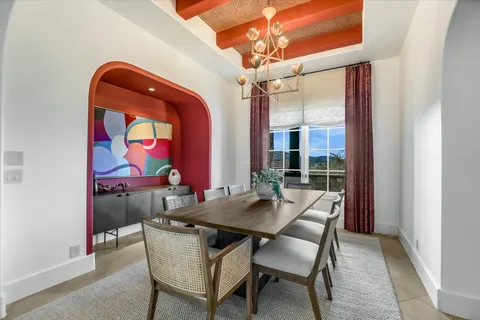 a view of a dining room with furniture and chandelier