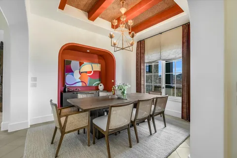 a dining room with furniture a rug and a painting