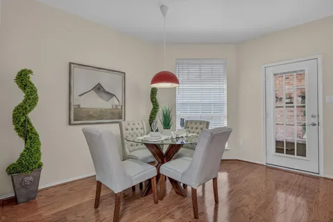 a dining room with furniture and wooden floor
