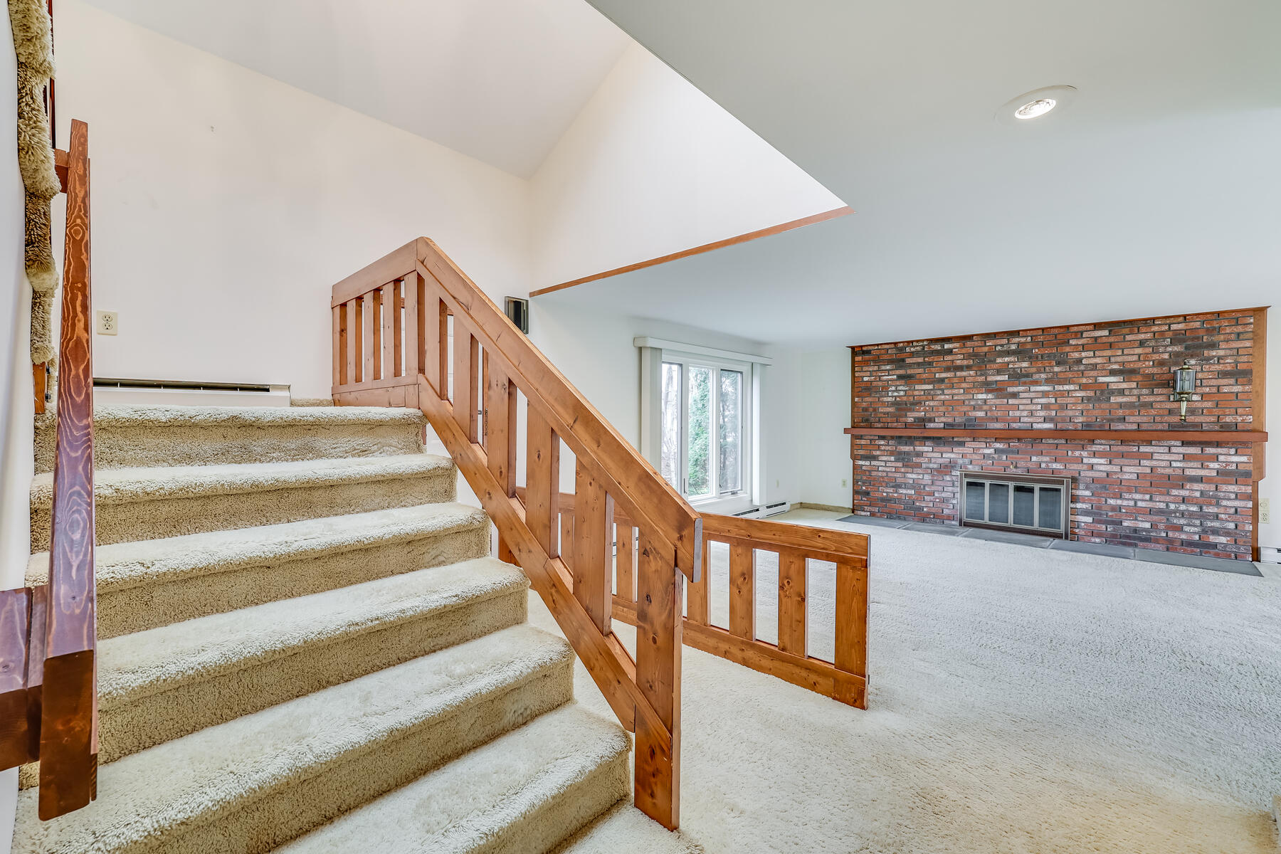 11 Menemsha Way East Falmouth, MA 02536 - Photo 26 of 50 a view of staircase with lots of frames on wall and a large window