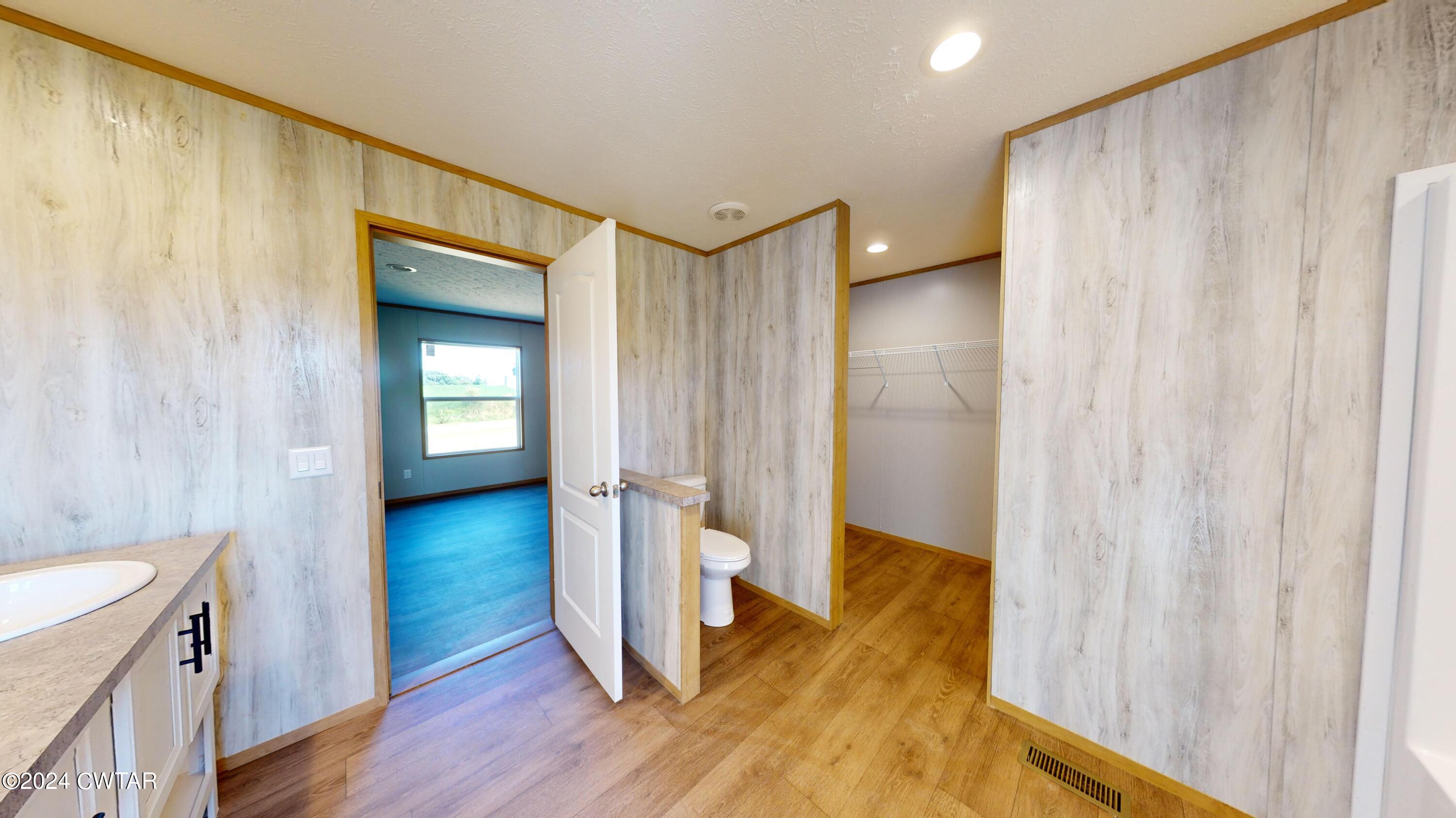 463 Peckerwood Point Road Newbern, TN 38059 - Photo 18 of 35 a view of a hallway with wooden floor and cabinet