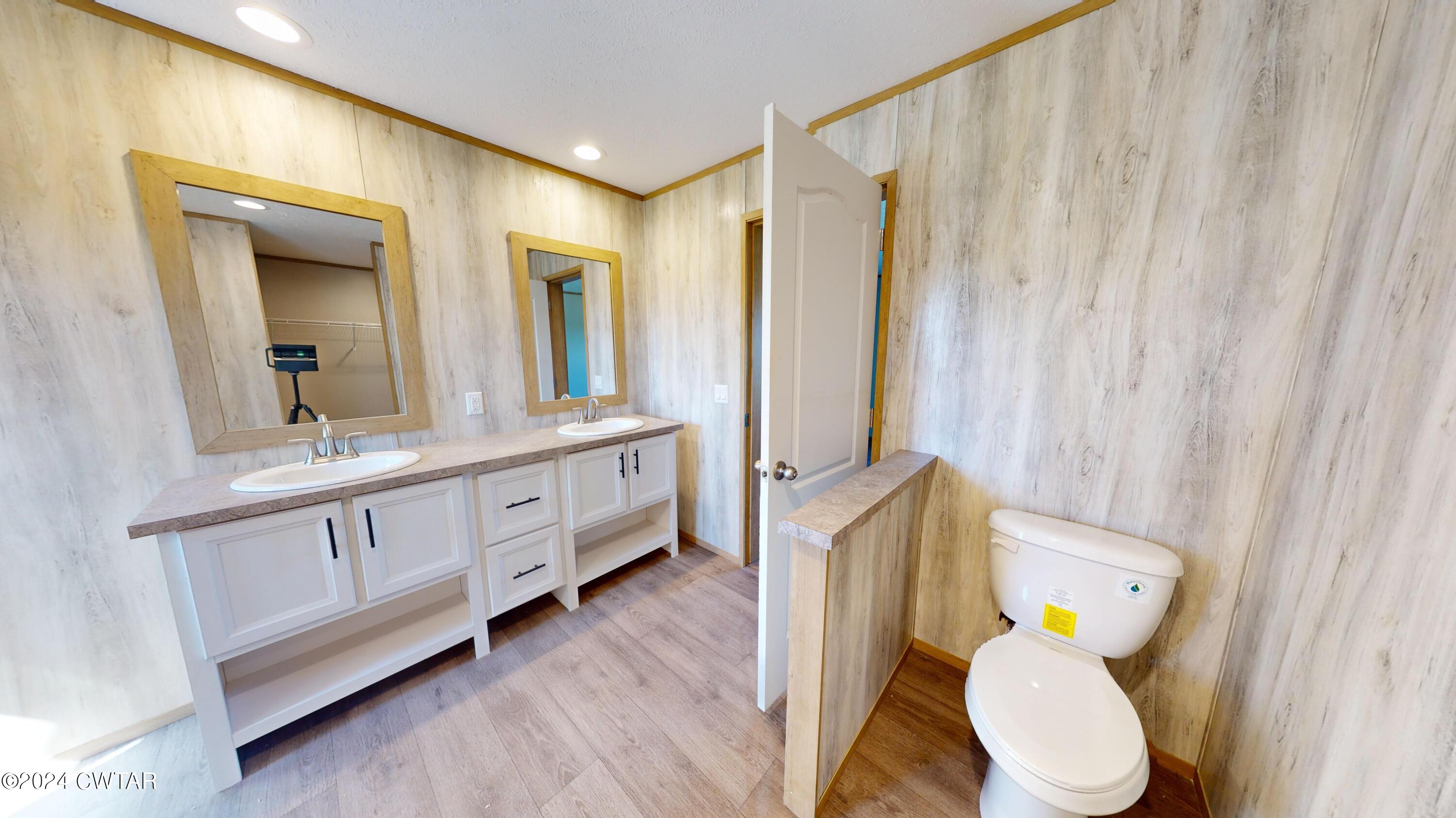463 Peckerwood Point Road Newbern, TN 38059 - Photo 19 of 35 a bathroom with a granite countertop toilet sink and mirror