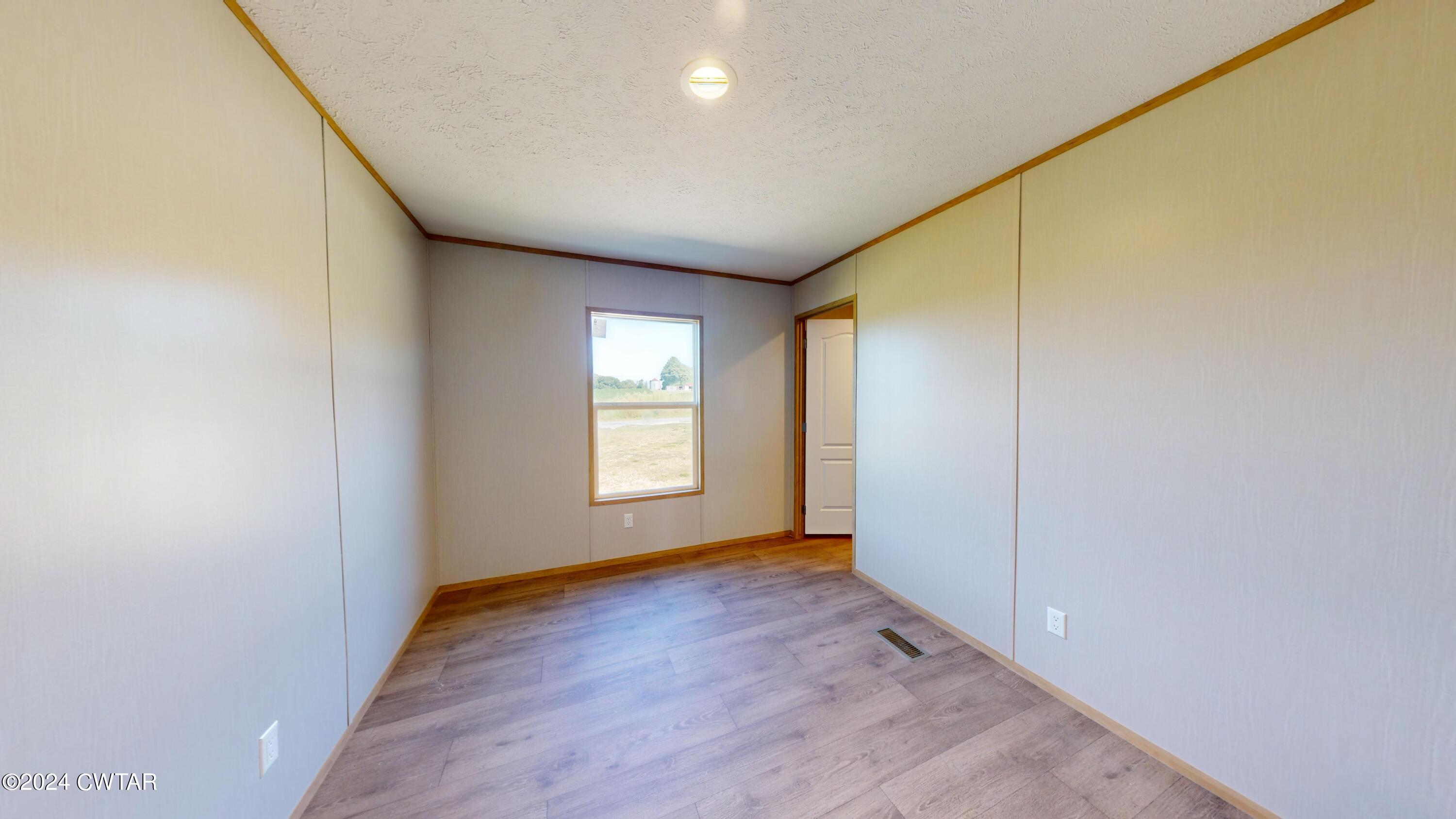 463 Peckerwood Point Road Newbern, TN 38059 - Photo 26 of 35 a view of an empty room with a window