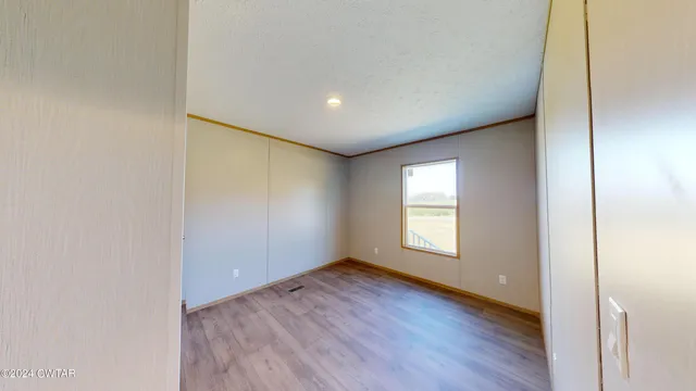 a view of hallway with wooden floor