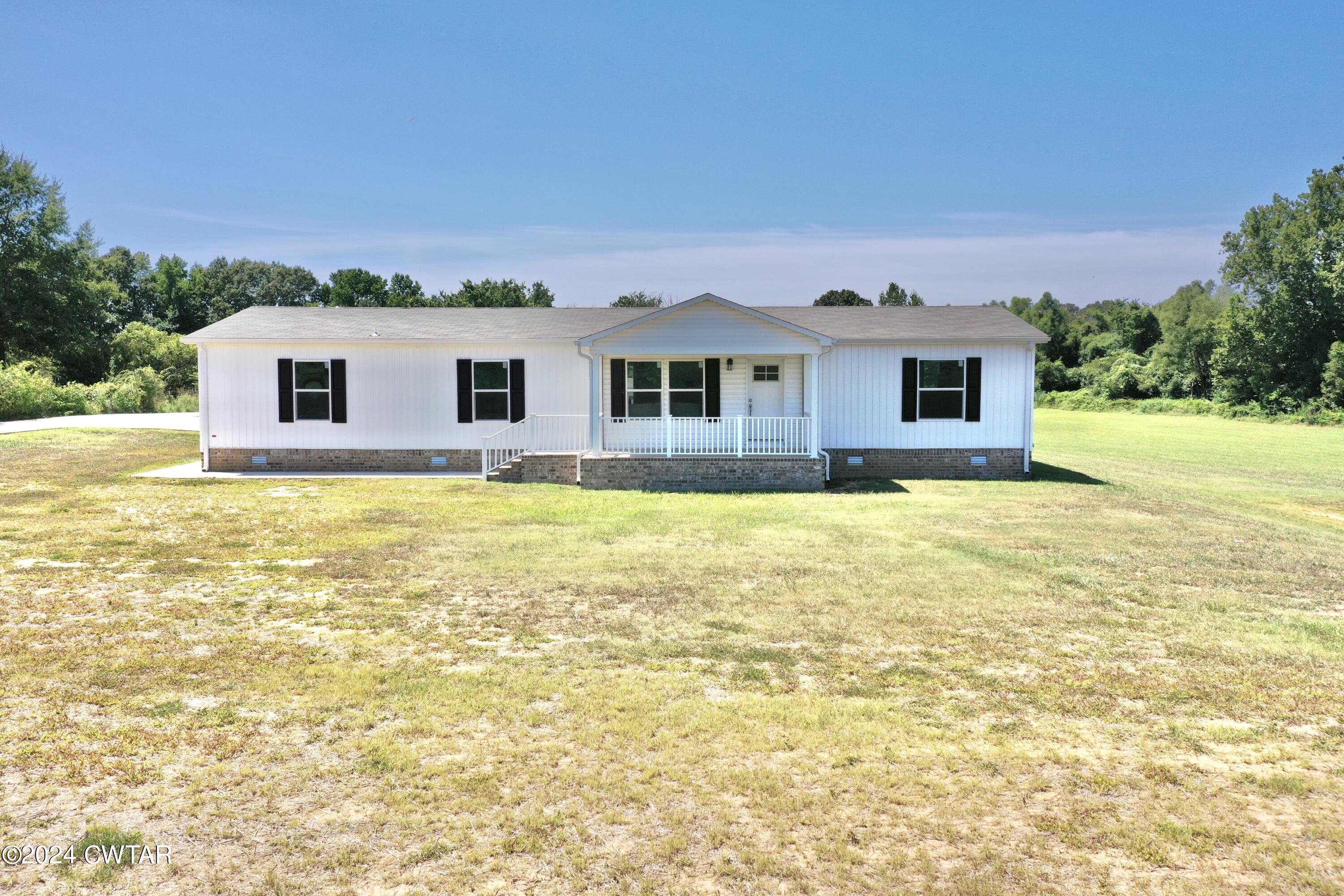 463 Peckerwood Point Road Newbern, TN 38059 - Photo 32 of 35 a house with swimming pool in front of it