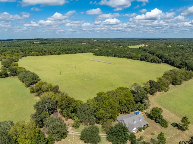 an aerial view of a houses with a lake