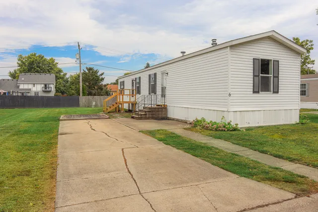 a backyard of a house with table and chairs