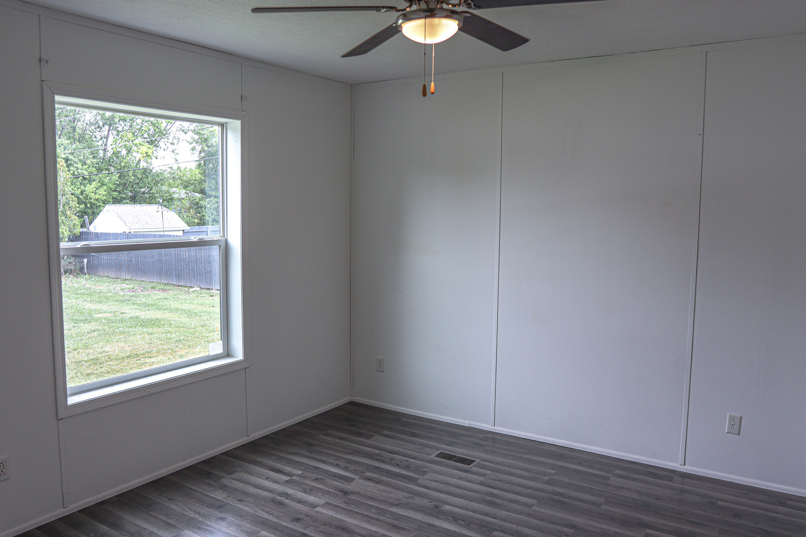 6 Countryside Estates Sandwich, IL 60548 - Photo 13 of 26 a view of an empty room with wooden floor and a window