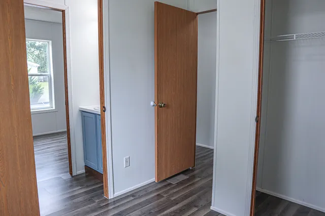 a view of hallway with wooden floor