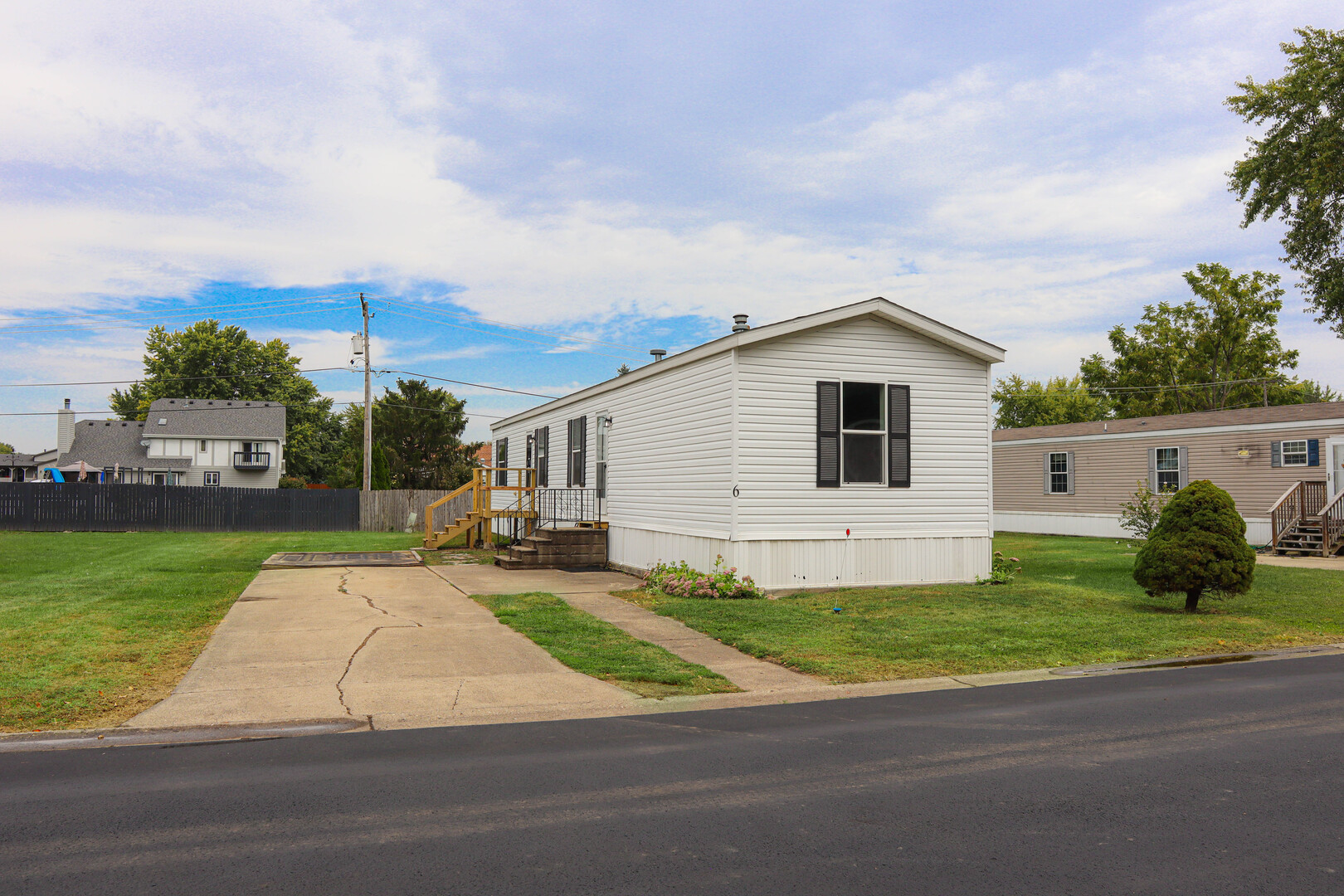 6 Countryside Estates Sandwich, IL 60548 - Photo 4 of 26 a white house with a yard and a large parking space