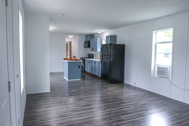 a view of kitchen and wooden floor