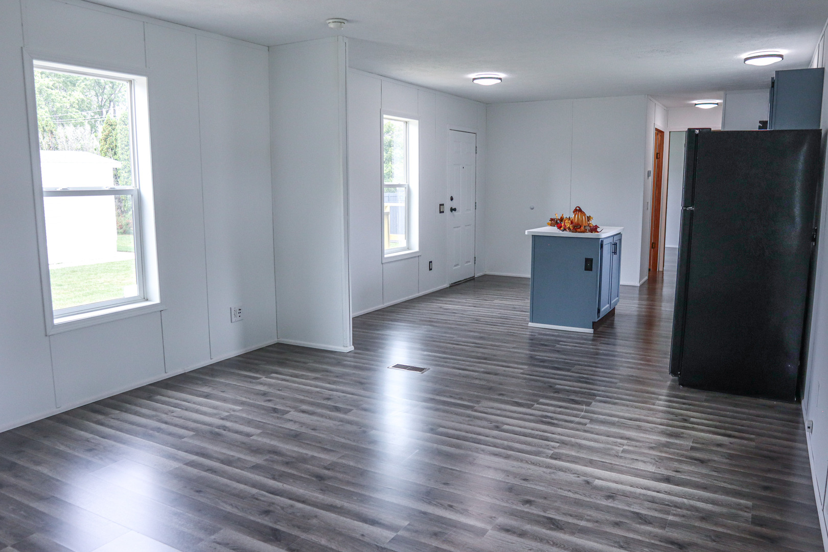 6 Countryside Estates Sandwich, IL 60548 - Photo 7 of 26 a view of a refrigerator in kitchen and an empty room with wooden floor