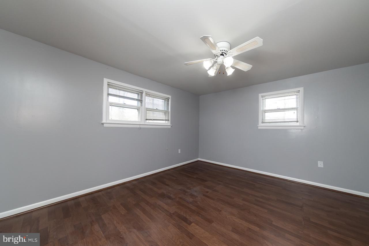 112 East 7th Avenue Pine Hill, NJ 08021 - Photo 11 of 27 a view of an empty room with window and wooden floor
