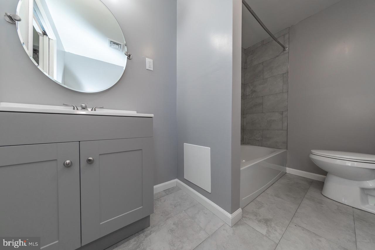 112 East 7th Avenue Pine Hill, NJ 08021 - Photo 12 of 27 a bathroom with a toilet a sink and bathtub