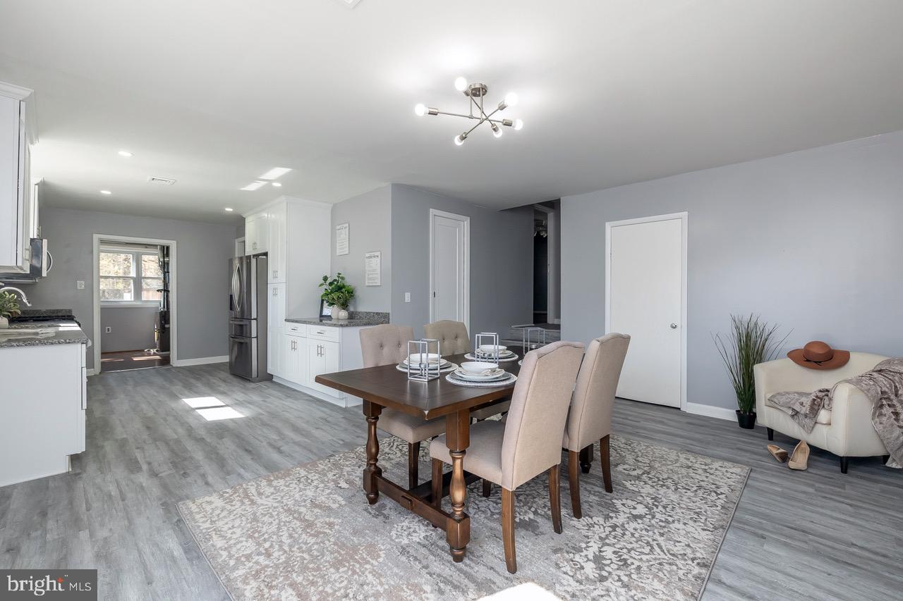 112 East 7th Avenue Pine Hill, NJ 08021 - Photo 19 of 27 a view of a dining room with furniture and wooden floor