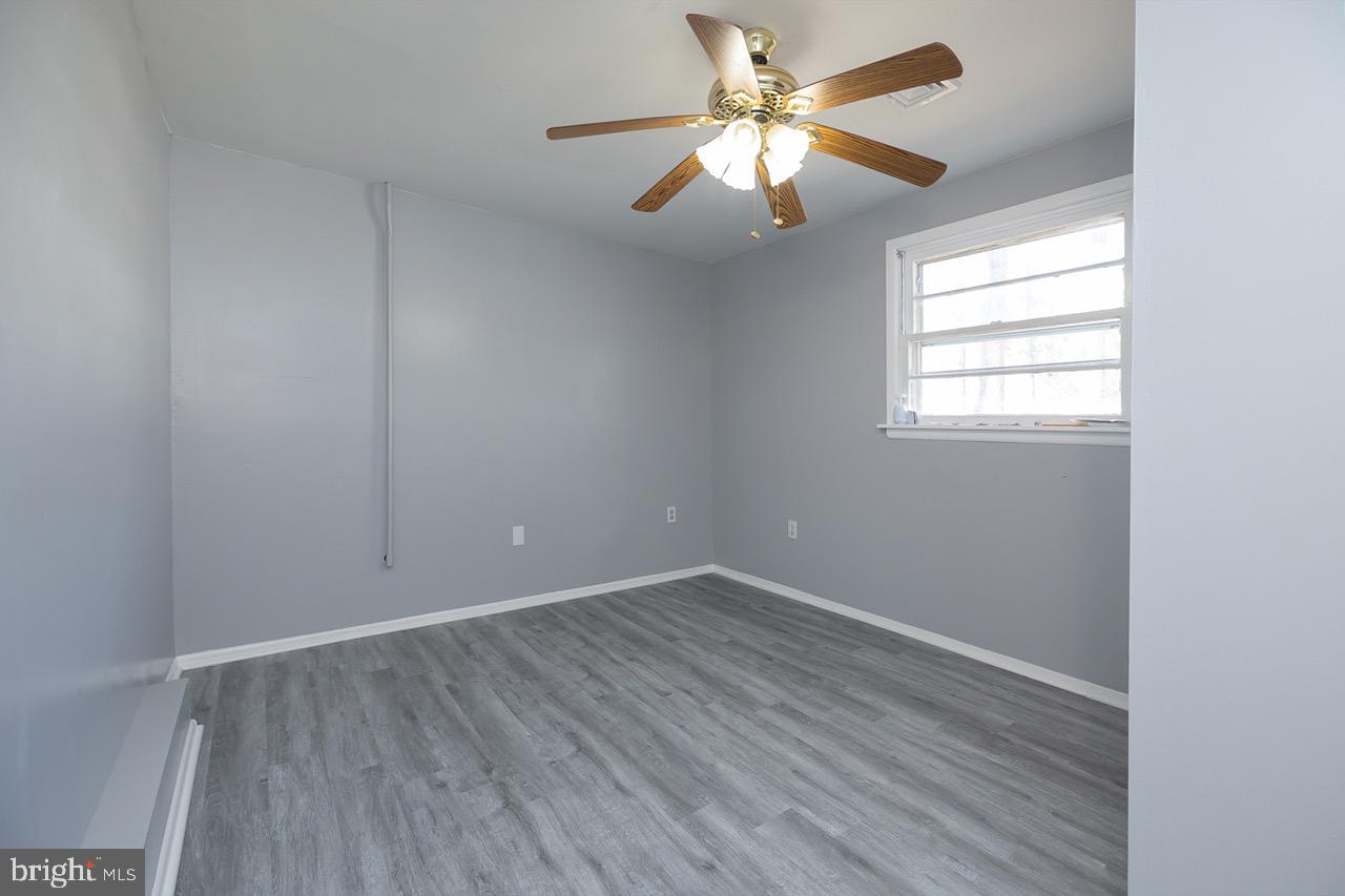 112 East 7th Avenue Pine Hill, NJ 08021 - Photo 9 of 27 wooden floor in an empty room with a window