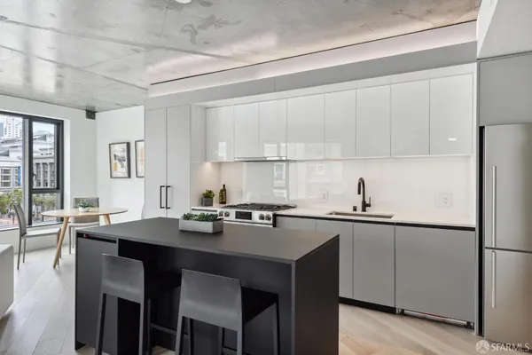 a kitchen with a sink cabinets and wooden floor