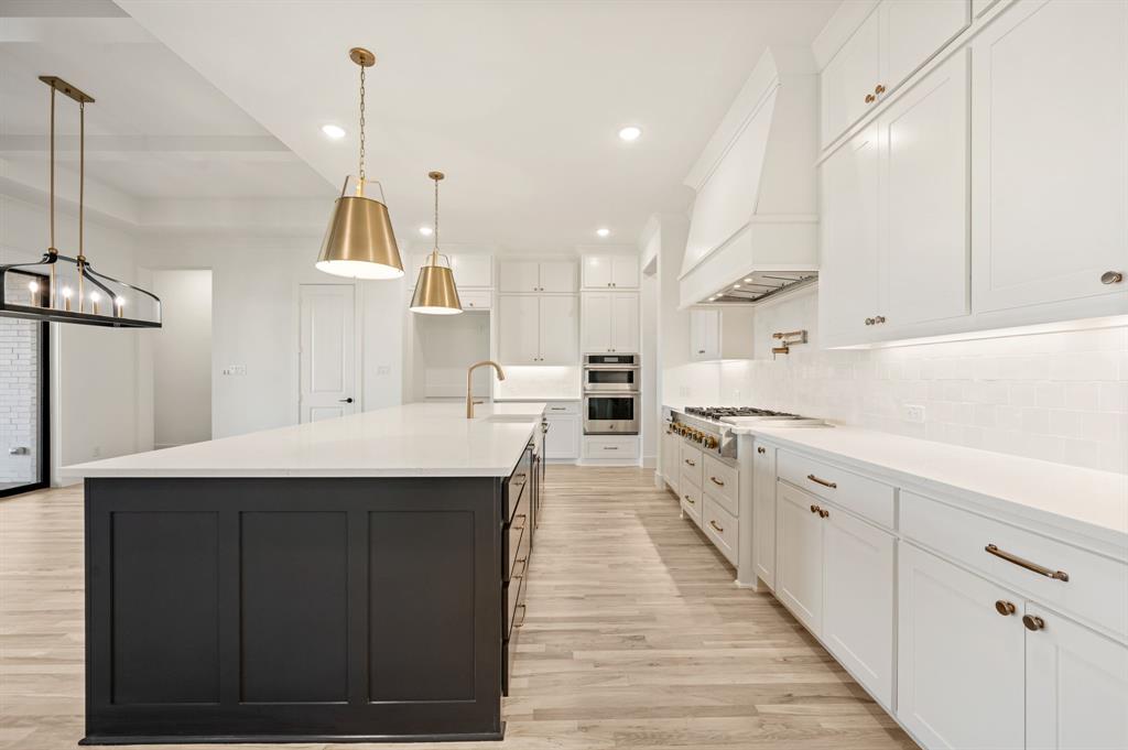 2139 Kingston Street Haslet, TX 76052 - Photo 13 of 40 a kitchen with kitchen island a sink stainless steel appliances and cabinets