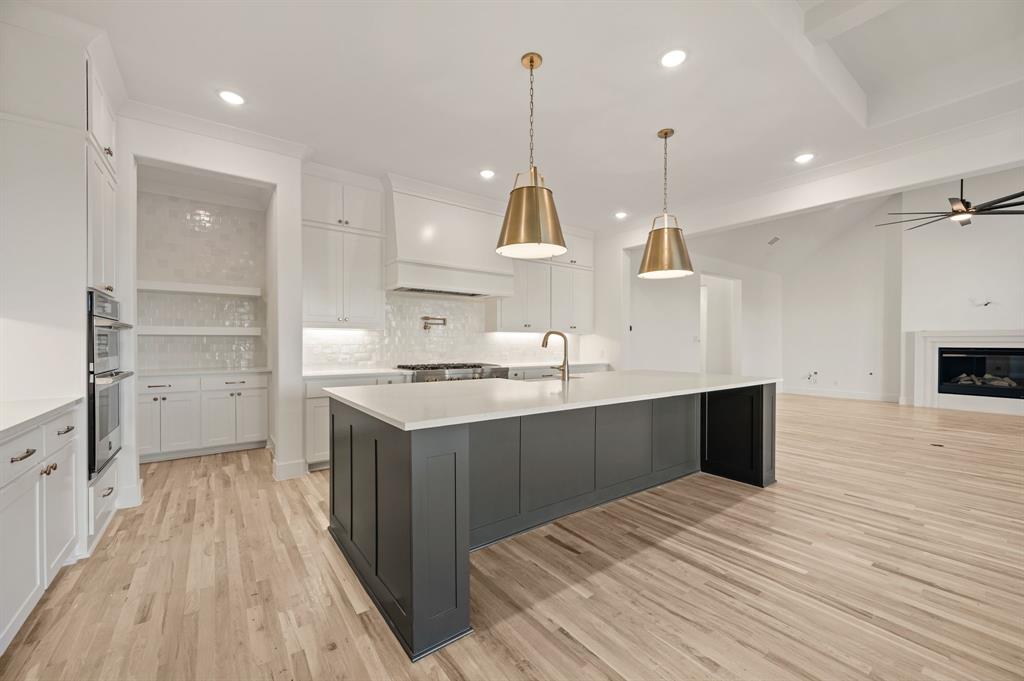 2139 Kingston Street Haslet, TX 76052 - Photo 16 of 40 a kitchen with kitchen island a sink appliances and cabinets