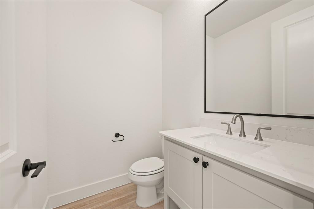 2139 Kingston Street Haslet, TX 76052 - Photo 19 of 40 a bathroom with a sink a toilet and mirror