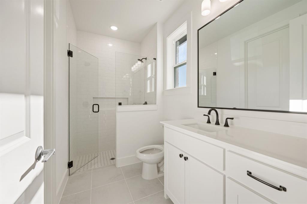 2139 Kingston Street Haslet, TX 76052 - Photo 26 of 40 a bathroom with a toilet sink a shower and