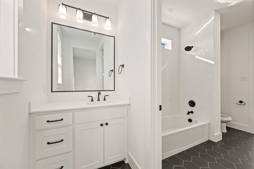2139 Kingston Street Haslet, TX 76052 - Photo 29 of 40 a bathroom with a bathtub sink mirror and toilet