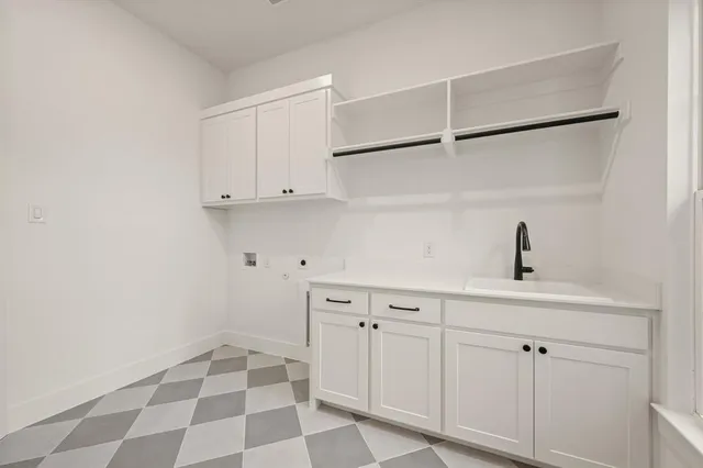 a view of a kitchen with white cabinets