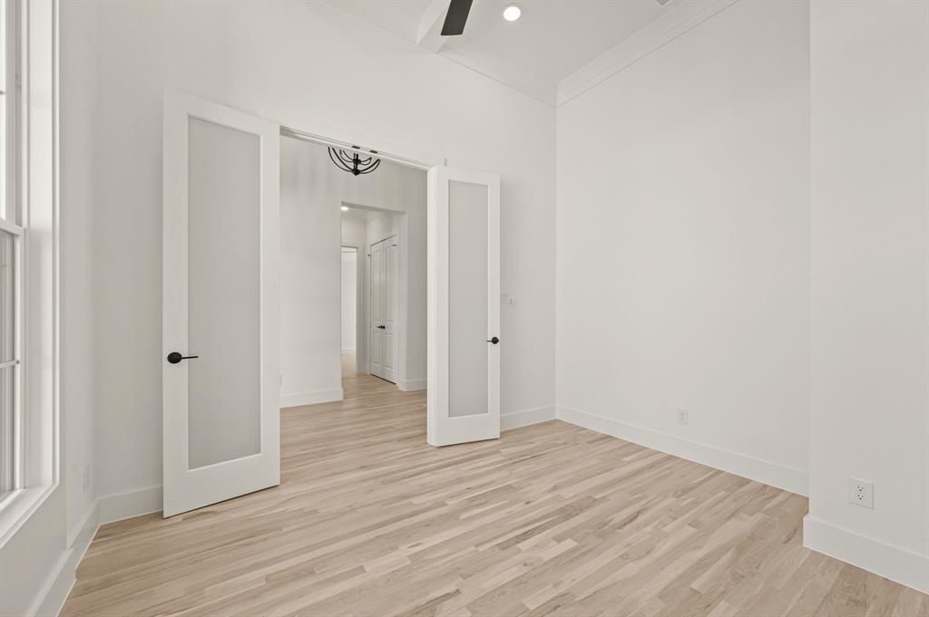 2139 Kingston Street Haslet, TX 76052 - Photo 6 of 40 a view of an empty room with wooden floor and a bathroom